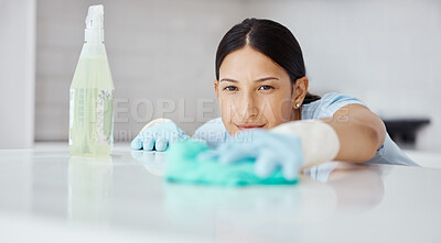 Buy stock photo Kitchen, product and cleaner cleaning a table with dirt or dust with detergent, cloth and gloves. Woman maid, domestic employee or housewife doing housekeeping in a modern office or house.