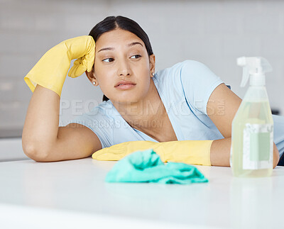 Buy stock photo Cleaning, covid and hygiene with a bored woman cleaner looking at a spray bottle or sanitizer with a negative expression. Chores, clean and sanitizing with a young female unhappy about housework