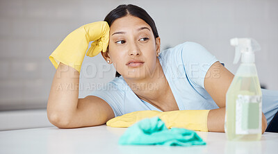 Buy stock photo Thinking, cleaner and woman at table in home tired of spring cleaning the kitchen interior. Housekeeper girl with domestic gloves and detergent unhappy, frustrated and moody with tidy job.