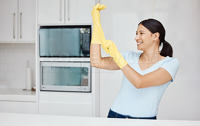 Buy stock photo Cleaning, safety and sanitizing with a woman cleaner in rubber gloves ready to do chores and house work. Hygiene, clean and wash with an attractive young female washing her home kitchen with a smile