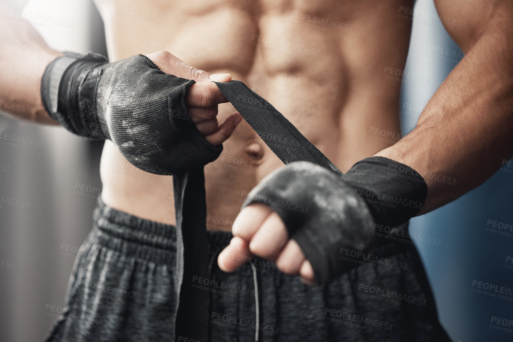 Buy stock photo Training, fitness and boxing man prepare for workout or match at gym or fitness center with hand wrap. Closeup of athletic boxer getting ready for strength, cardio and endurance kickboxing challenge