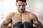 Fighter, sport and boxing gloves on strong man or athlete boxer doing serious training, exercise and muay thai in gym or fitness club. Portrait, wellness and fighting arab professional ready to fight