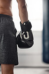 Boxer, fighter glove and hand close up at sports club or gym for training with equipment for fist. Athlete sportswear for protection for mma and boxing fight or workout with safety gear.