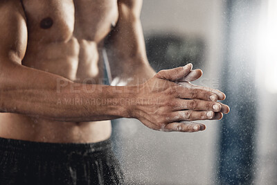 Buy stock photo Man with sports chalk powder on his hands in the gym during a fitness training or workout. Closeup of a muscular guy with active, healthy and wellness lifestyle preparing for boxing or weightlifting