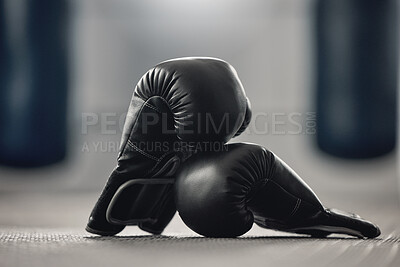 Buy stock photo Boxing gloves on the floor of a gym after exercise, training and workout. Pair of sport handwear or equipment on the ground after fighting match, practice or punching in a competitive sports club