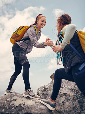 Buy stock photo Hiking, help and friends out on a rock or mountain climbing adventure for fitness, exercise and adrenaline. Happy women with support, travel and assistance while out on cliff and reaching the summit