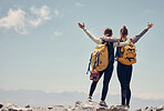 Hiking friends celebrate climbing mountain peak together on rocky summit as healthy, fitness and trekking women. Success, freedom and happy climbers adventure, challenge or journey with mockup space