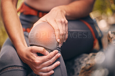 Buy stock photo Knee, pain and injury with a hiker suffering with a painful leg getting hurt while trekking or exercise training. Cgi, special effects and overlay with the hands of female hiking outside in nature
