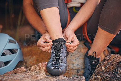Buy stock photo Woman tying her hiking shoes in nature preparing for a rock climbing or trekking exercise. Fitness, footwear and healthy girl doing outdoor sports activity or adventure on a mountain for wellness.