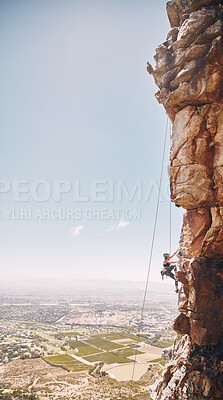 Buy stock photo Person rock climbing on a mountain cliff for a challenge in nature with a blue sky and copy space. Woman climber on a rock wall for a fitness workout, exercise and sports training outdoors.