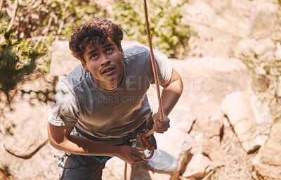 Buy stock photo Man on rock in nature, climbing mountain with with safety equipment and outdoor clothes to show courage. Young healthy guy hiking cliff, on extreme fitness adventure or exercise journey.