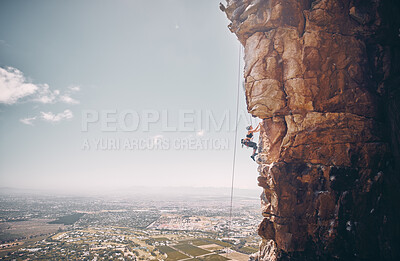 Buy stock photo Mountain, rock climbing and sport with a sports woman and climber abseiling on a mountainside outdoor in nature. Fitness, exercise and training with a female athele using a rop to climb a cliff