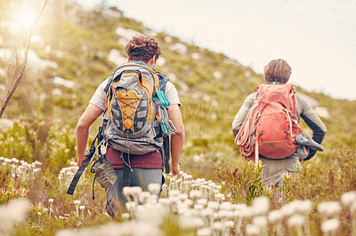 Buy stock photo Hiking couple, nature and walking on mountain, hill or environment nature countryside with wildflowers in France. Man and woman with backpack on break, fitness or exercise in relax workout for health