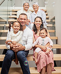Portrait of a happy family posing for a picture on stairs in a house, smiling and relaxing together. Happy children bonding and enjoying time with their parents on a visit to their grandparents home 