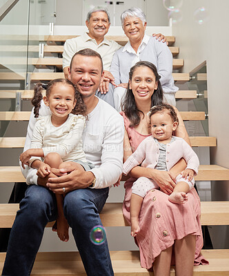 Buy stock photo Portrait of a happy family posing for a picture on stairs in a house, smiling and relaxing together. Happy children bonding and enjoying time with their parents on a visit to their grandparents home 