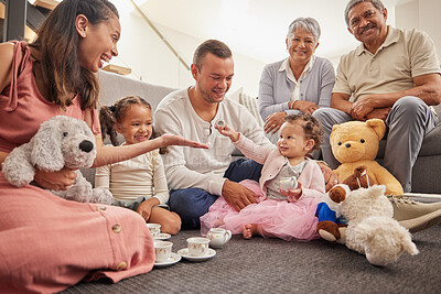 Buy stock photo Big family portrait in kids room with tea party toys for play and bonding together on the floor. Happy grandparents, mother and father with baby in their family home having fun sitting on the ground