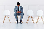 Hr recruitment, man and alone with chair row empty in corporate office waiting room for meeting. Professional interview, candidate selection and rejection in the job hiring career process.
