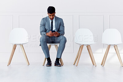 Buy stock photo Human resources, recruitment and man on chair with phone in empty corporate office waiting room. Professional company interview for candidate and rejection in the job career hiring process.