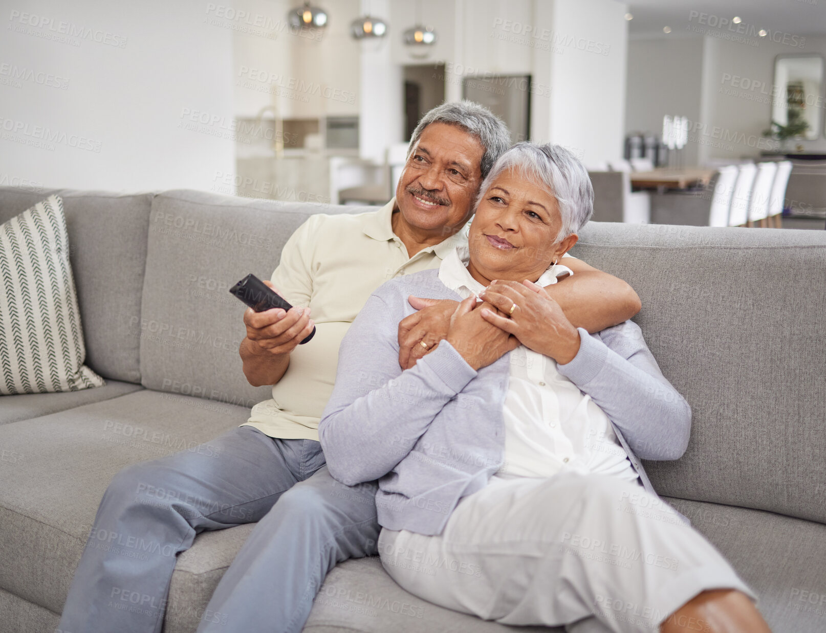 Buy stock photo Movie streaming, living room and senior couple at home with quality time together on a sofa. Elderly people smile and hug on a house lounge couch watching tv with a relax, peace and love mindset 