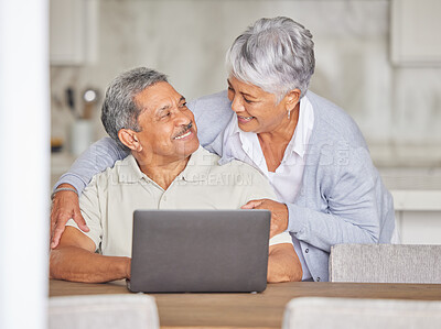Buy stock photo Happy elderly couple streaming on laptop, hug and bonding while relax in kitchen at home. Senior man and woman indoors, enjoy retirement and relationship, talking while browsing for subscription