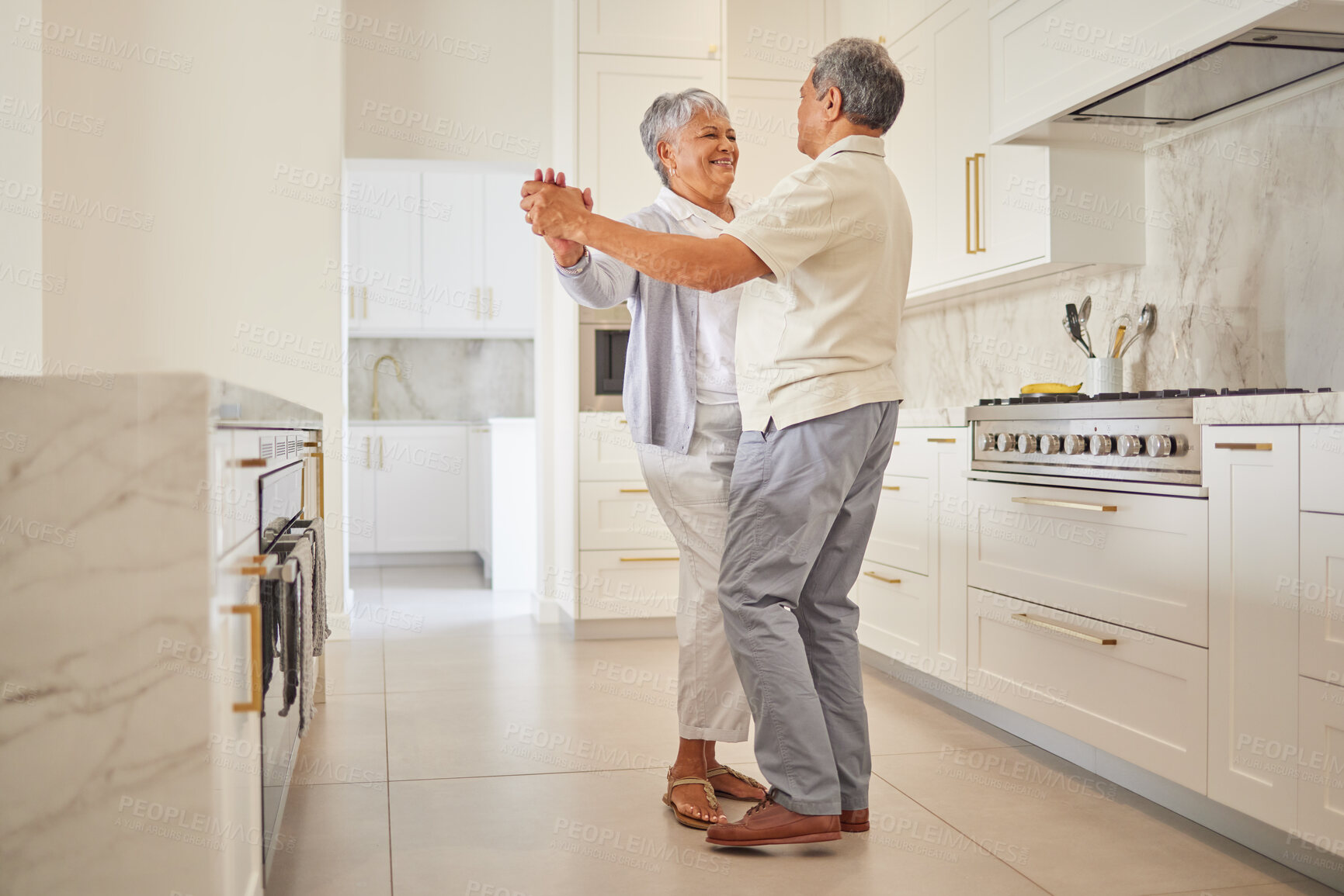 Buy stock photo Senior couple dance, kitchen and elderly love of people spending quality time together at home. Happy retirement of a woman and man from Mexico dancing in their house with a smile and happiness
