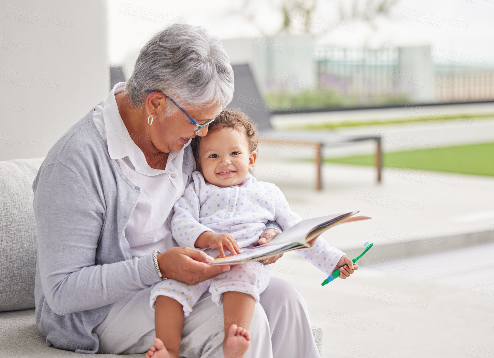 Buy stock photo Senior woman, happy baby and children book reading of a grandmother spending quality time together. Elderly retirement of a old female about to read a fun kids story to a kid on a home patio 