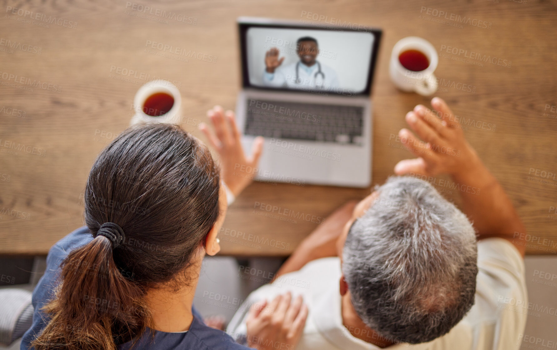 Buy stock photo Senior couple with a laptop on a video call with a doctor for consultation during lockdown above. Man and woman talk, wave and telehealth with medical healthcare expert to consult on health at home
