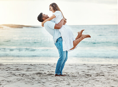 Buy stock photo Man at beach lift woman with love, smile with sun setting over the horizon or background. Young couple travel to ocean on vacation, happy together with sunset over sea or waves in nature backdrop.