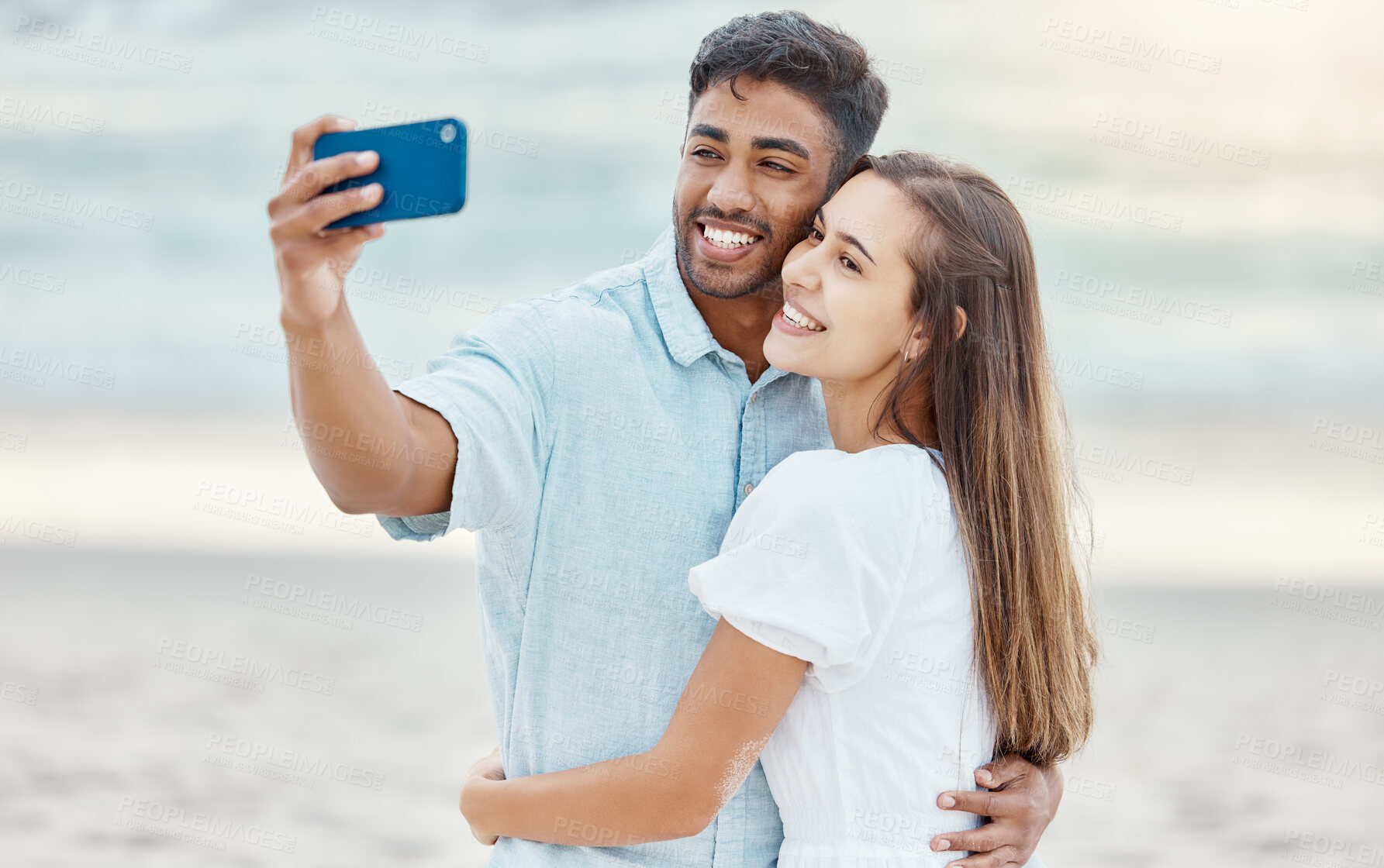 Buy stock photo Couple, beach selfie and smile for happy travel fun, freedom day and relaxing summer vacation outdoors. Photos and young people celebrate with love hug on holiday, romance together and honeymoon date