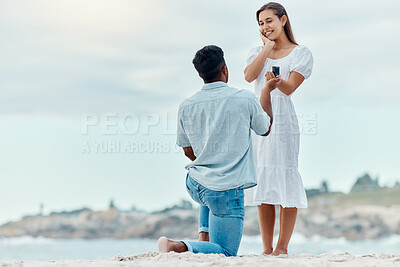 Buy stock photo Beach proposal, engagement and surprise woman for love, care and relationship commitment together. Young, engaged and happy marry me couple, summer seaside date and special romance marriage outdoors
