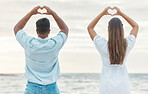 Couple hands, back heart love sign and passion, affection or romantic emoji by the ocean. Romance, man and woman, hand symbol or emotion shape, intimacy or adoration, support or devotion gesture.

 
