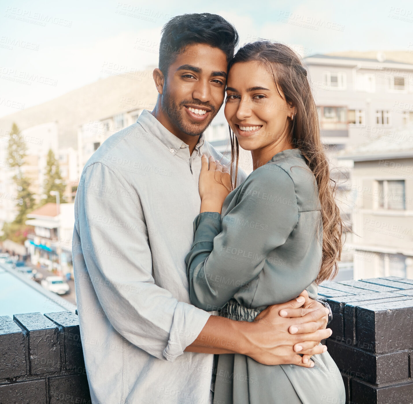 Buy stock photo Love, couple and travel with a man and woman tourist hugging on a balcony in a foreign city together. Romance, dating and diversity with a young male and female on honeymoon overseas or abroad