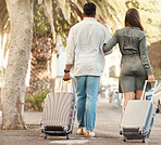 Couple, walking and travel with luggage on vacation for honeymoon in city street abroad. Married man and woman on summer international holiday with bags while walk on a road with fashion clothing