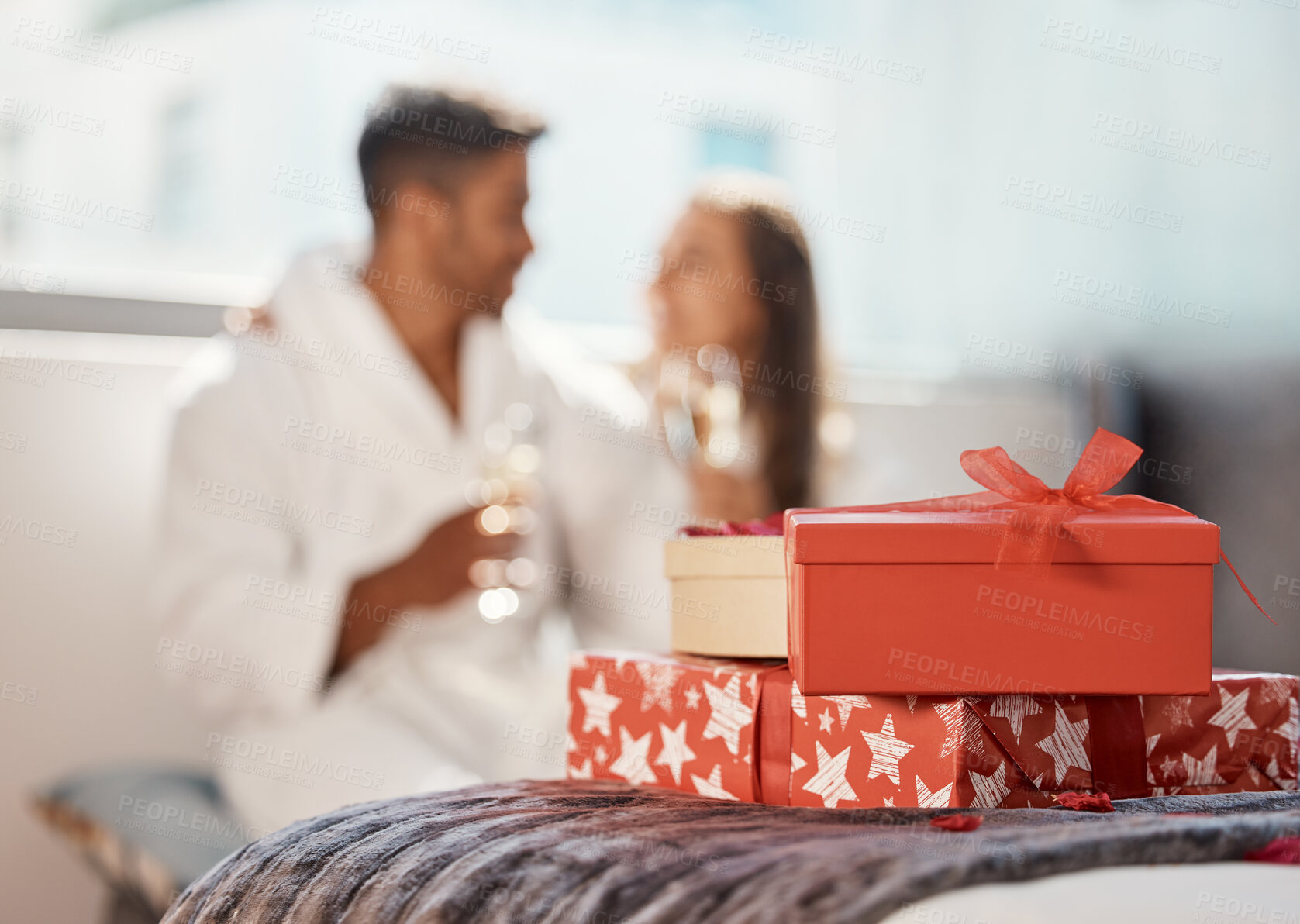 Buy stock photo Christmas gift, present and happy couple celebrate the holiday at hotel with champagne. Love, happiness and vacation celebration of a girlfriend and boyfriend smile and drink in a bedroom together