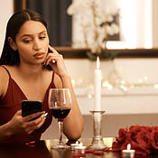 Wine, restaurant and sad woman with smartphone on date app ...