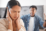 Woman scared, noise and abuse from angry man in the living room at home. Fear, bullying and sad wife cover ears as husband shout, scream or yelling at home with marriage conflict, drama or fight