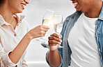 Celebrate, toast and couple with champagne for anniversary, date or luxury travel vacation together. Love, cheers and happy with hands of man and woman holding glass of wine for joy, drink and event