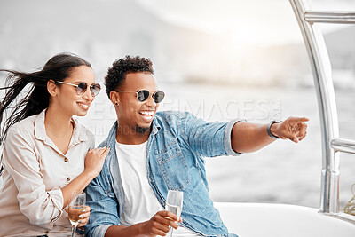 Buy stock photo Couple love to travel on a luxury yacht at sea together on a romantic date in nature on a holiday vacation. Smile, happy and young boyfriend and woman enjoy champagne in the ocean on a boat cruise