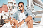 Luxury, wine glass and man on a yacht for holiday vacation on the ocean or sea with sunglasses. Gen z entrepreneur portrait enjoying his wealth with champagne glass on cruise boat travel in summer