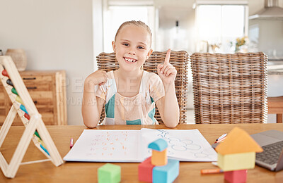 Buy stock photo Education, learning and child development with girl drawing and doing homework at a kitchen table at home. Portrait of a happy student smile, enjoying distance learning and educational art project