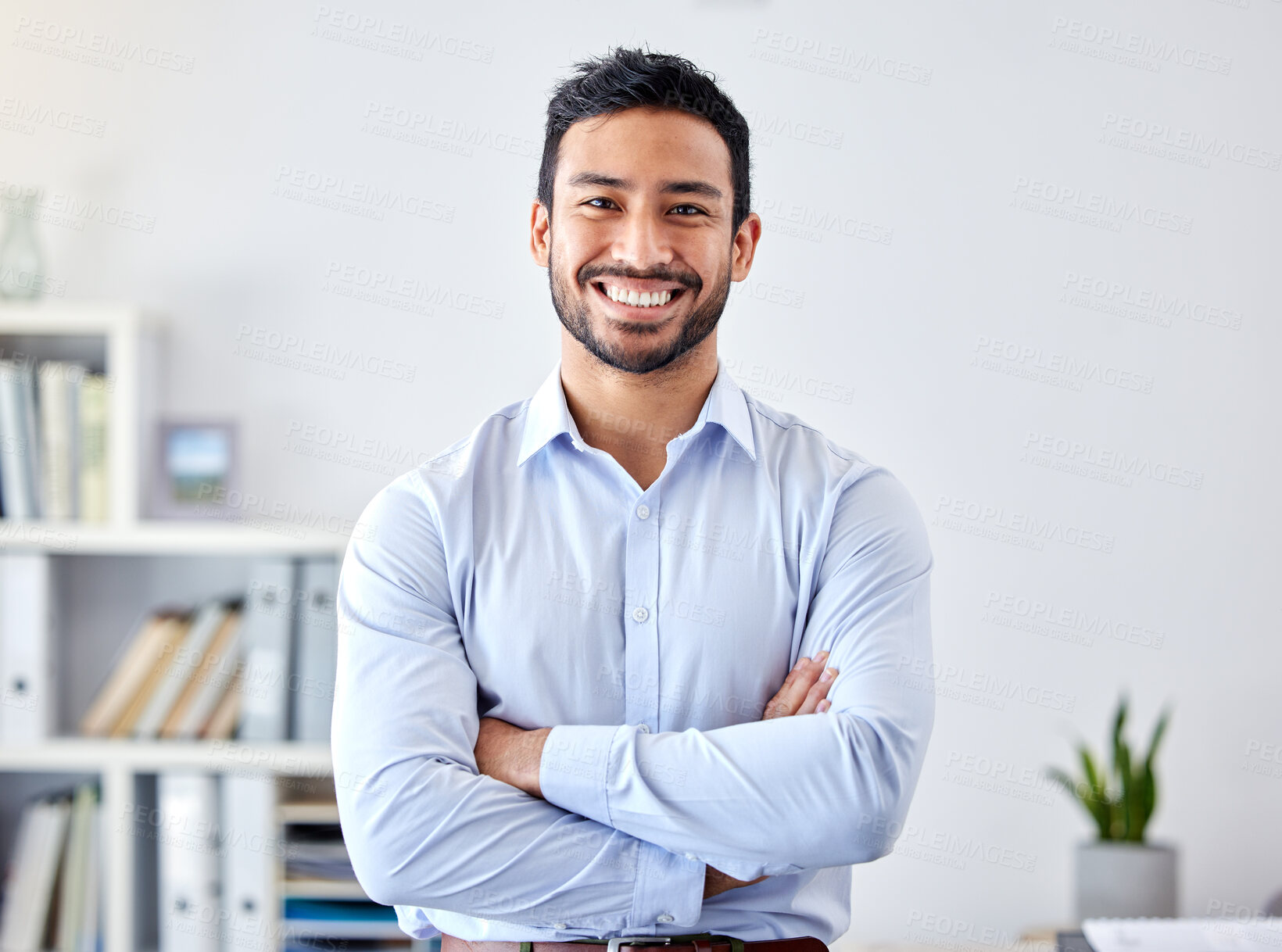 Buy stock photo Portrait of a businessman with a smile in a corporate modern office of a startup company. Happy, career and professional manager or entrepreneur standing with his arms crossed in his workspace.