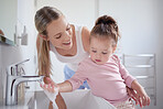 Bathroom, clean and washing hands with child and mother teaching hygiene with running tap water in basin. Family, health and protection against virus with mom and baby learning a cleaning routine 