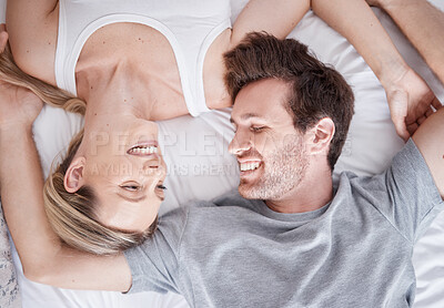 Buy stock photo White happy couple above, smile and bed relaxing together in happiness for relationship, bonding and care at home. Man and woman smiling in love, lying and relax for bedroom time and break in comfort