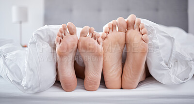 Buy stock photo Relax, couple feet and bedroom blanket for comfort while resting with partner in house. Love, intimate relationship and morning nap with people laying with a bed cover together in home.
