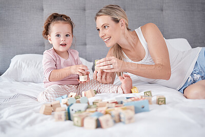 Buy stock photo Mom play education game with toys, on bed with child for growth and fun together. Mother smile in bedroom with toddler girl, learning alphabet and cognitive development in home with building blocks