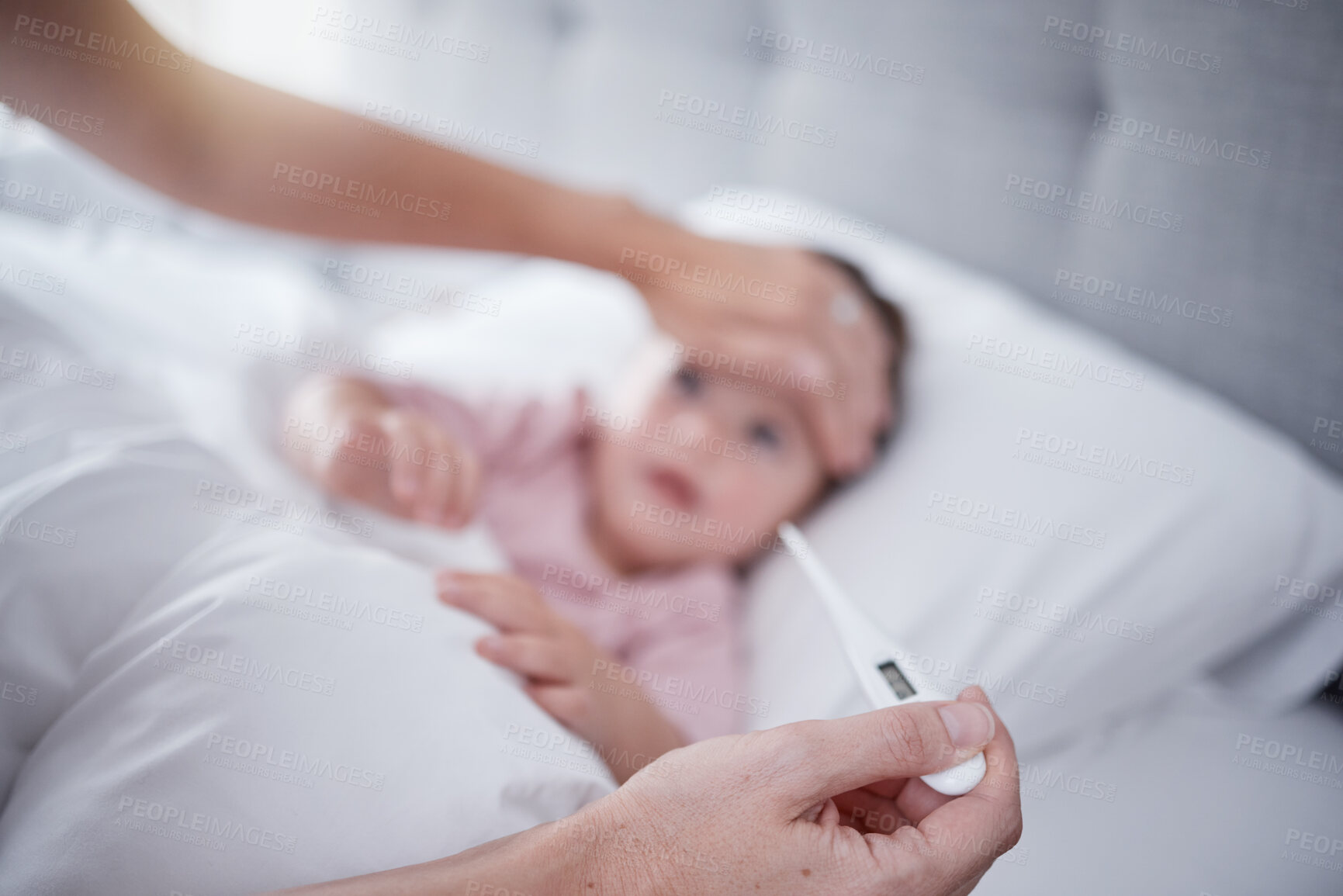 Buy stock photo Hands, fever and baby with the hand of a mother taking the temperature with a thermometer of a sick daughter in bed at home. Female parent measuring or testing the symptoms of her girl in the bedroom