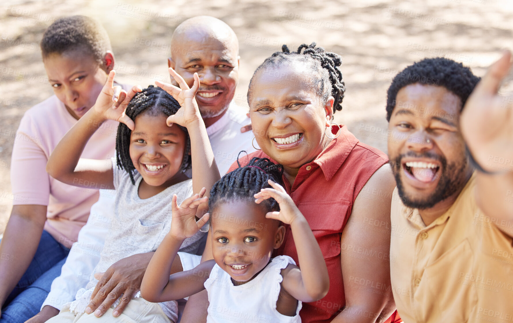 Buy stock photo Portrait, happy black family and smile for selfie sitting and bonding in free time together in the outdoors. African father taking a silly photo with kids, wife and grandparents on a summer vacation