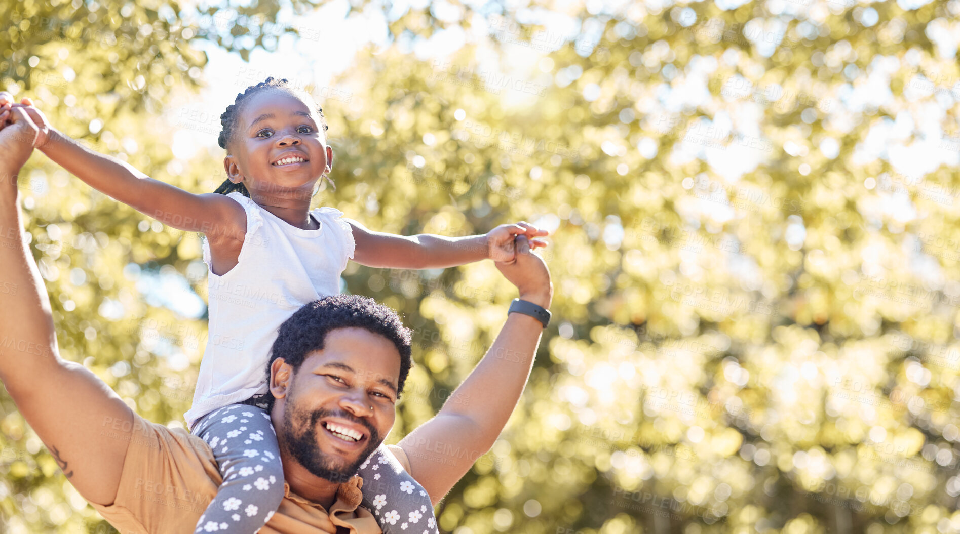 Buy stock photo Happy, playful and fun father and girl in their backyard on a sunny day. Portrait of energetic dad playing and bonding with his child. African family smile and spend time together on the weekend