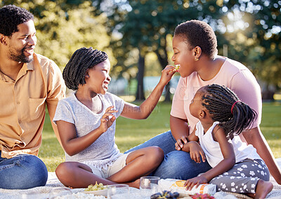 Buy stock photo Picnic, summer and happy with black family in park, eating fruit together for care, bonding or holiday. Vacation, happy family and health with parents and children sitting in countryside environment