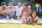 Food, drink and a family picnic in park with kids, parents and grandparents. Men, women and children relax outdoors in nature. Eating, drinking and laughing, a happy black family outside with girls.